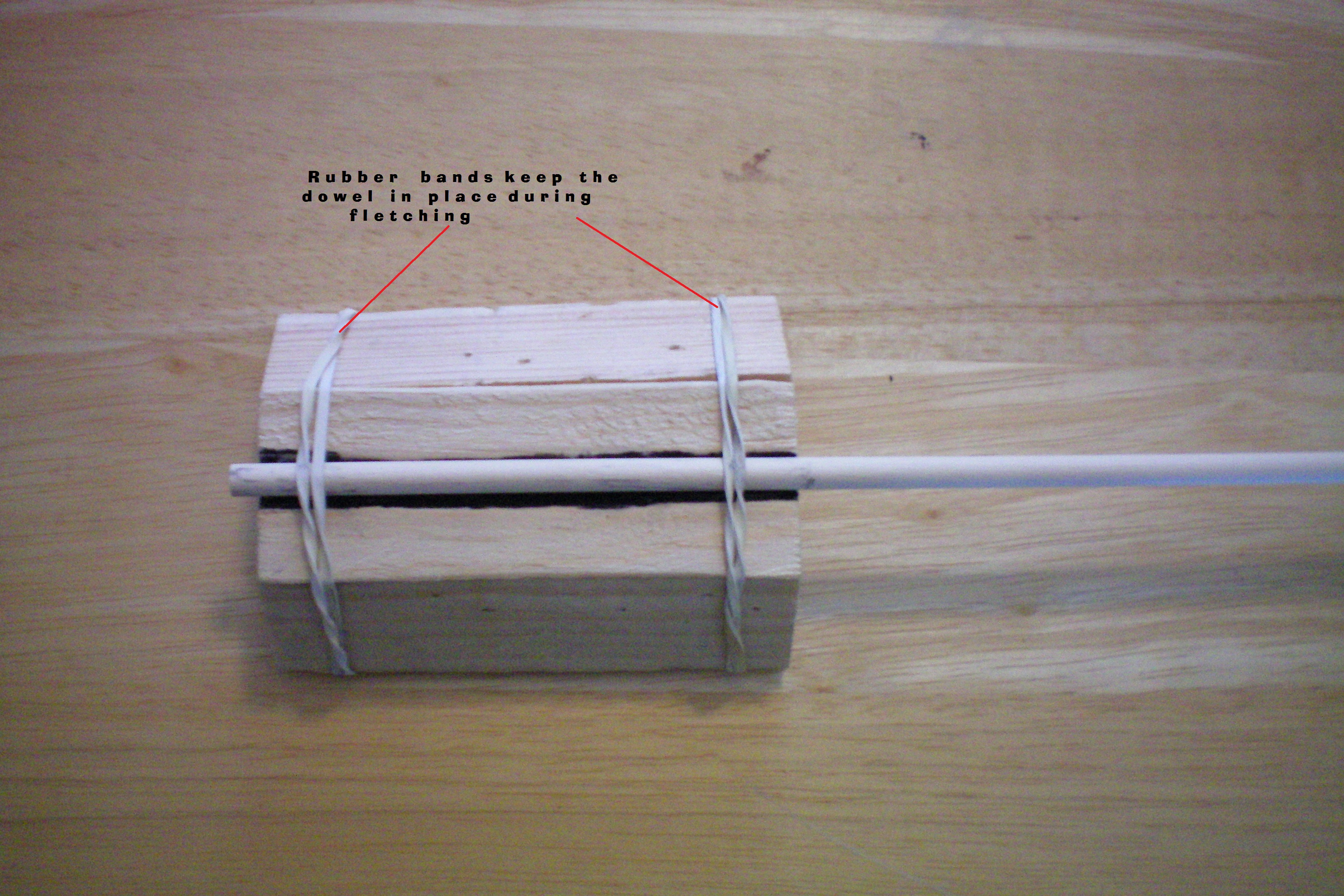 026 labeled Use two rubber bands to keep the dowel in place.JPG