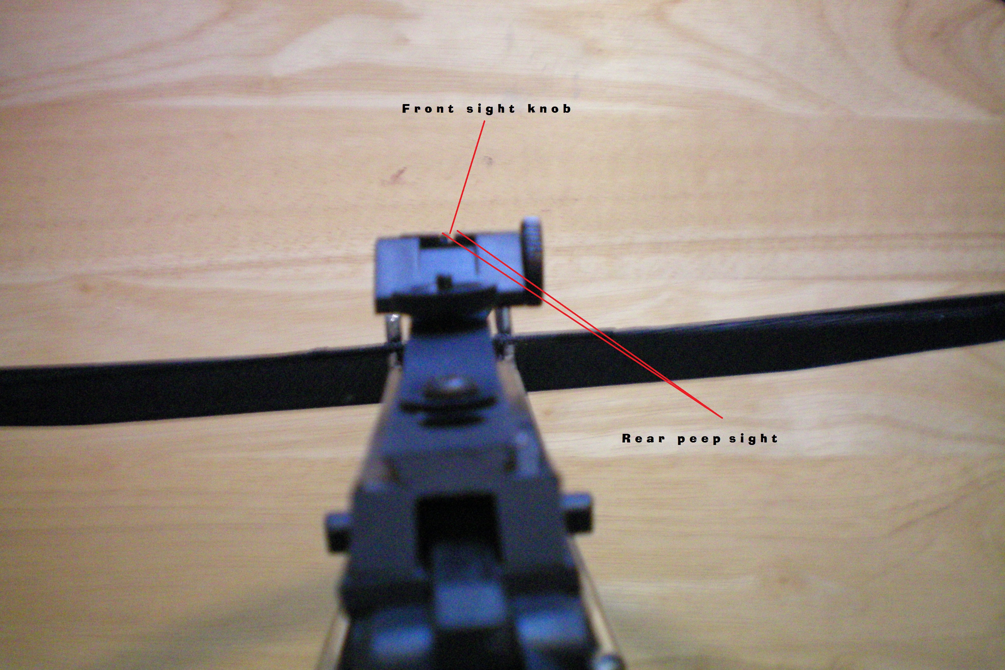 06 labeled Align the rear peep site with the front knob sight.JPG