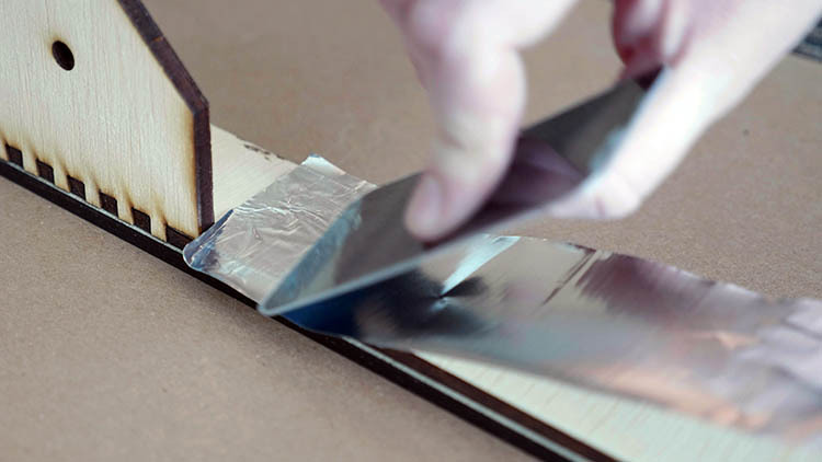 23-applying-foil-tape-to-laser-cut-plywood.jpg