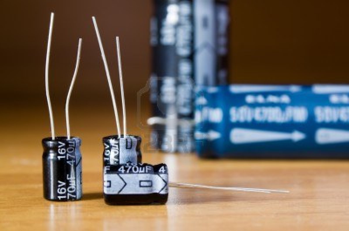 9092890-three-little-electrolytic-capacitors-on-the-table.jpg