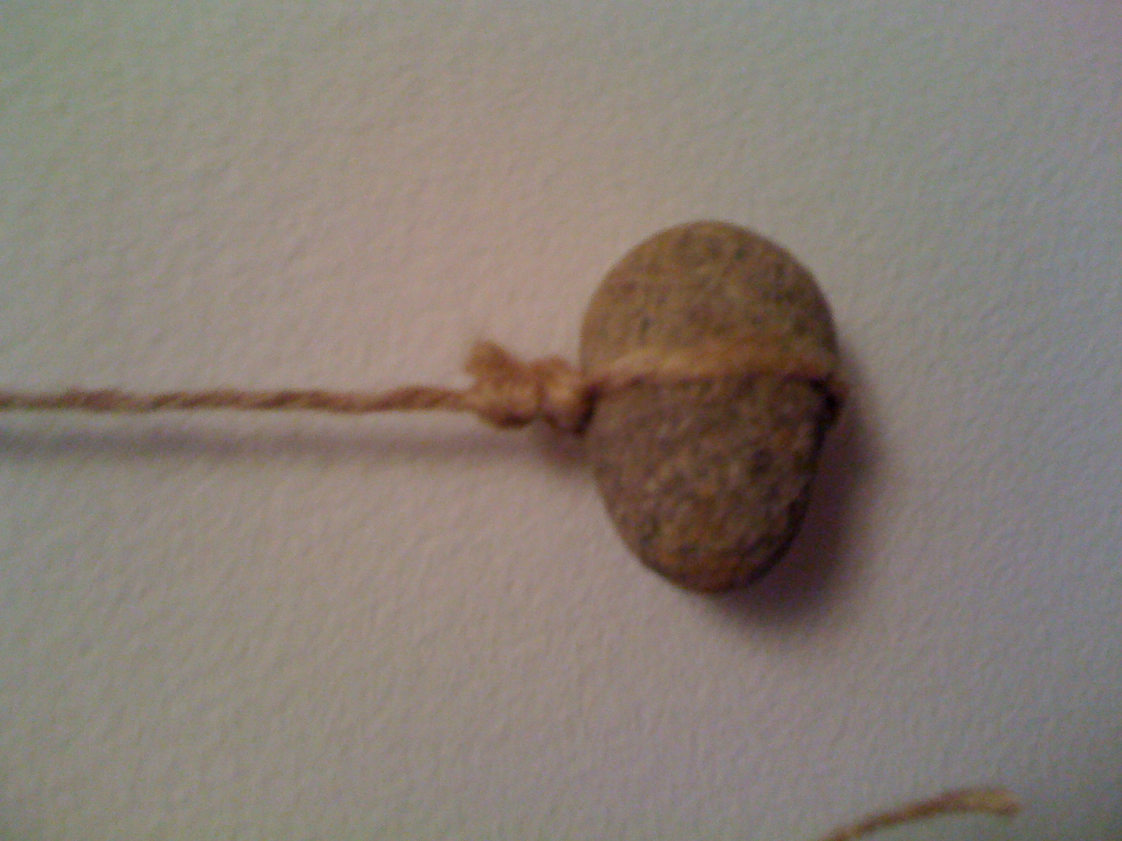 Bola rock with string attached.JPG