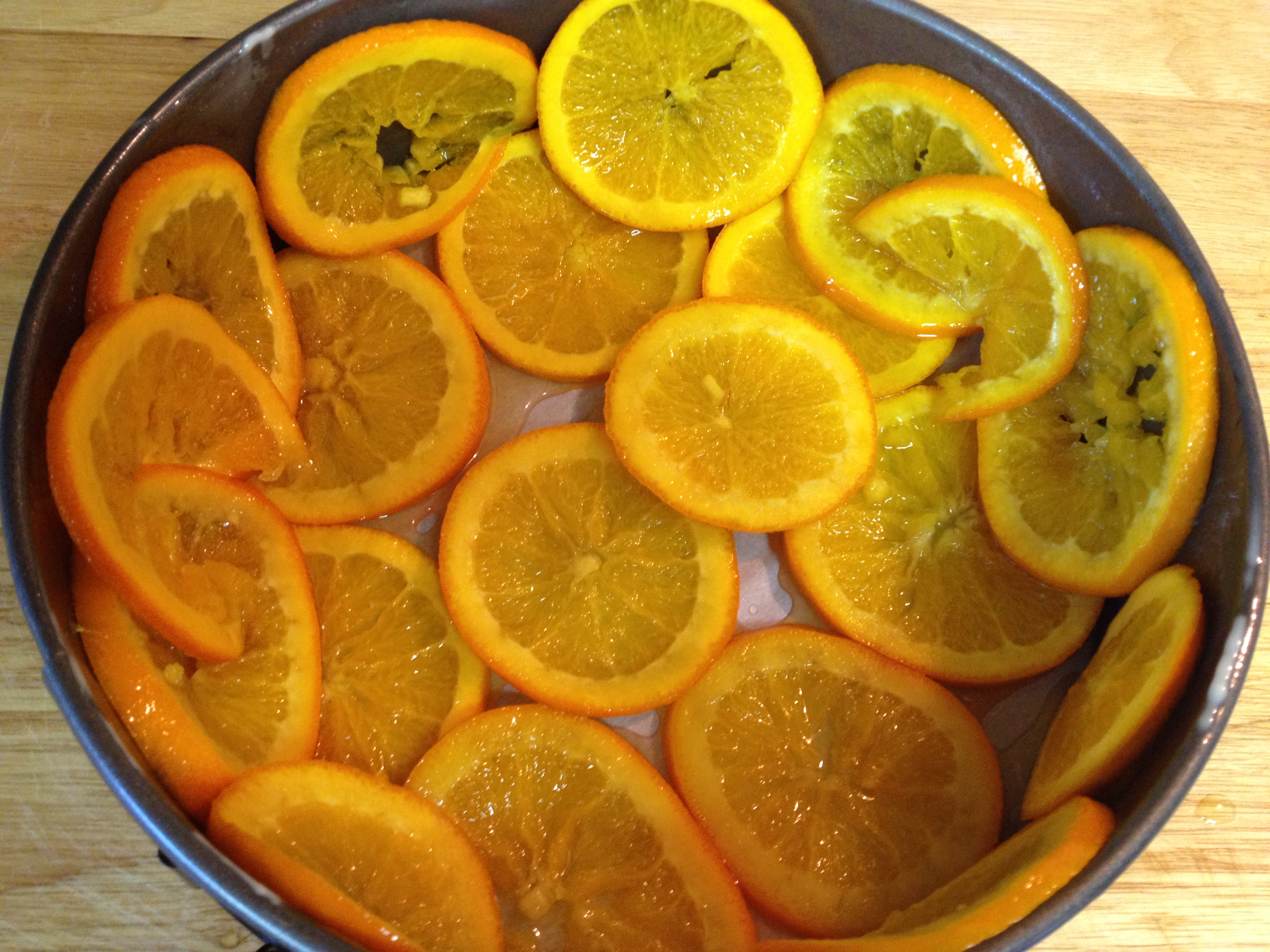 Candied orange slices placed on the bottom and sides of the spring-form pan.jpg