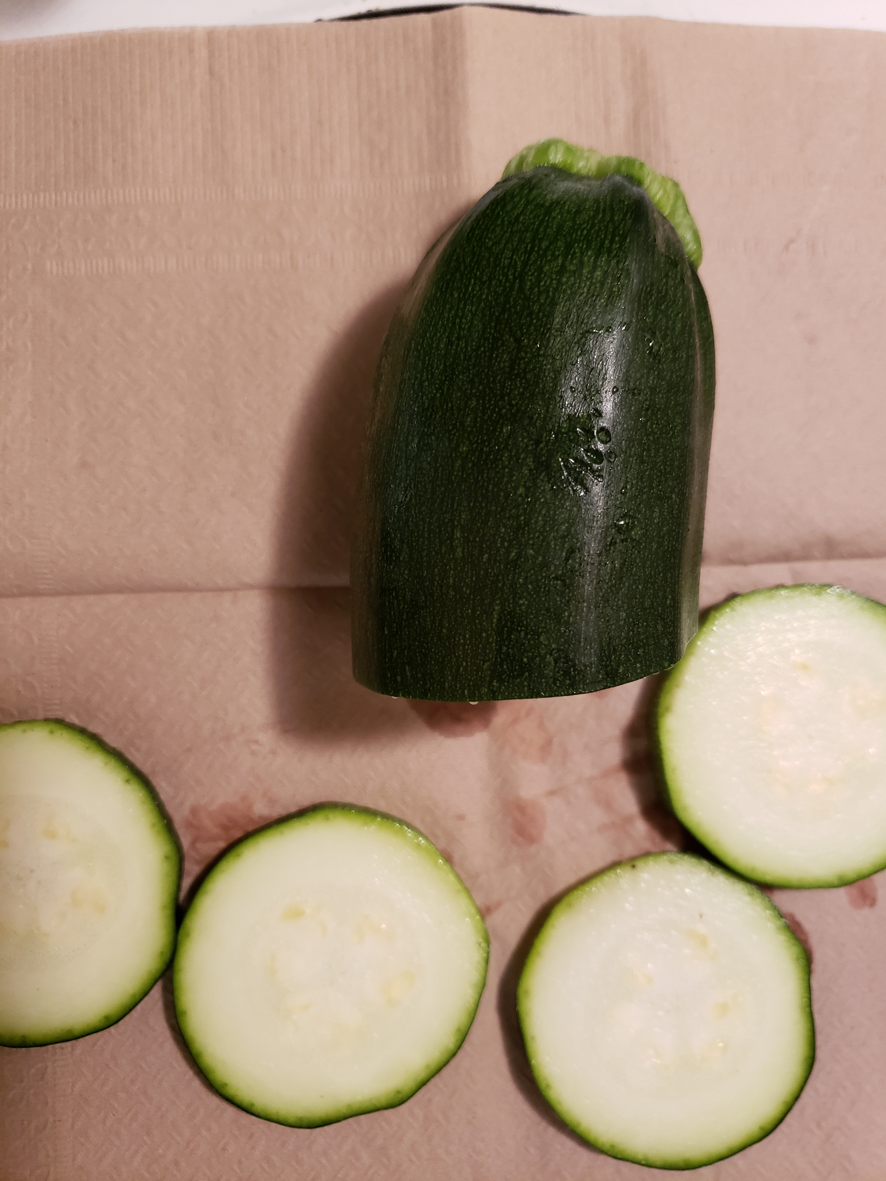 Cut off from fresh organic zucchini one eighth inch thick portions.jpg