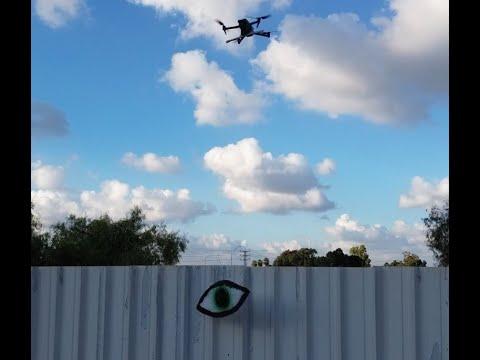 Drone hang street art on fence