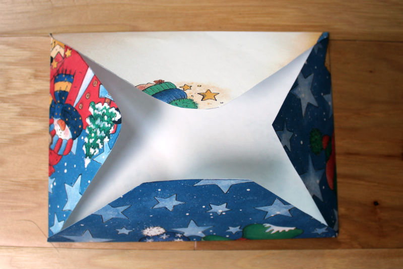 Folded scrap book paper for homemade Christmas envelope.jpg