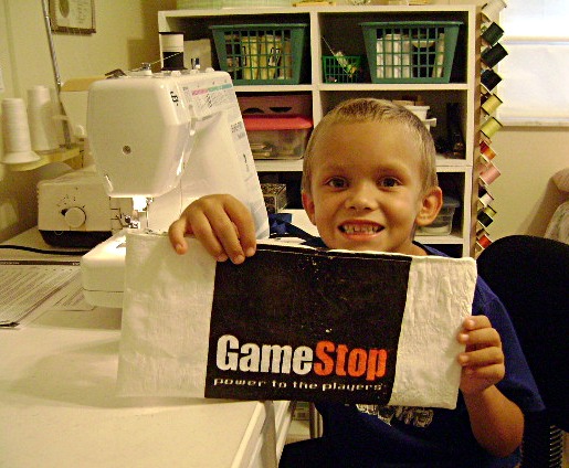 Gavin holding Game Stop bag.JPG