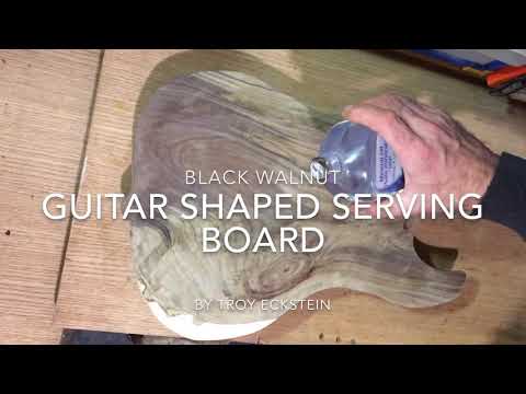 Guitar-shaped walnut serving board