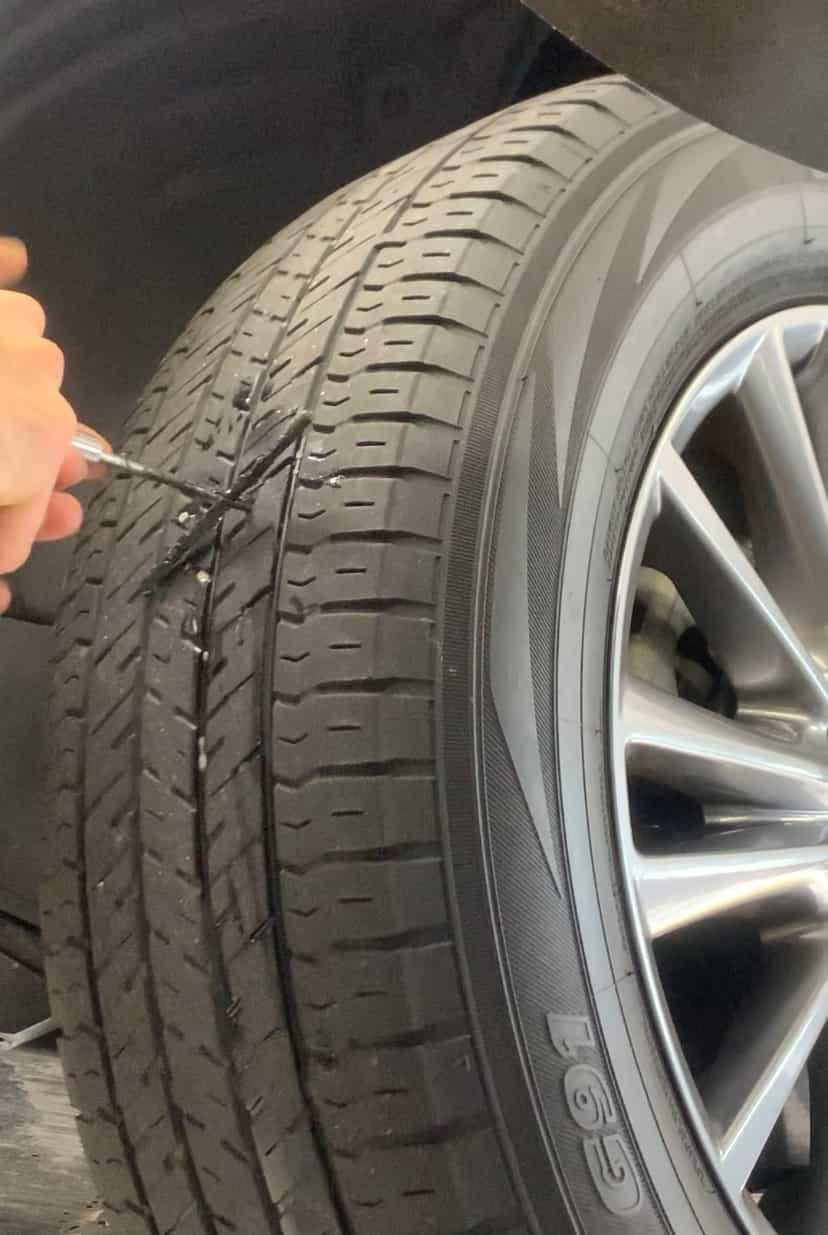 INSERTING TIRE PLUG ON TIRE ON CAR.jpg