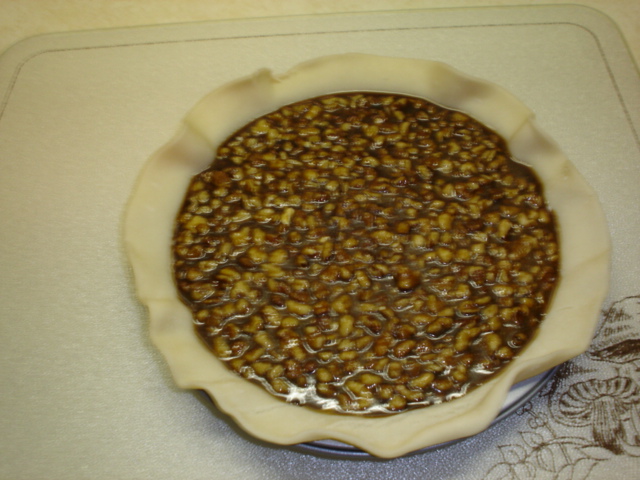 K pour walnut mix into pie crust.JPG