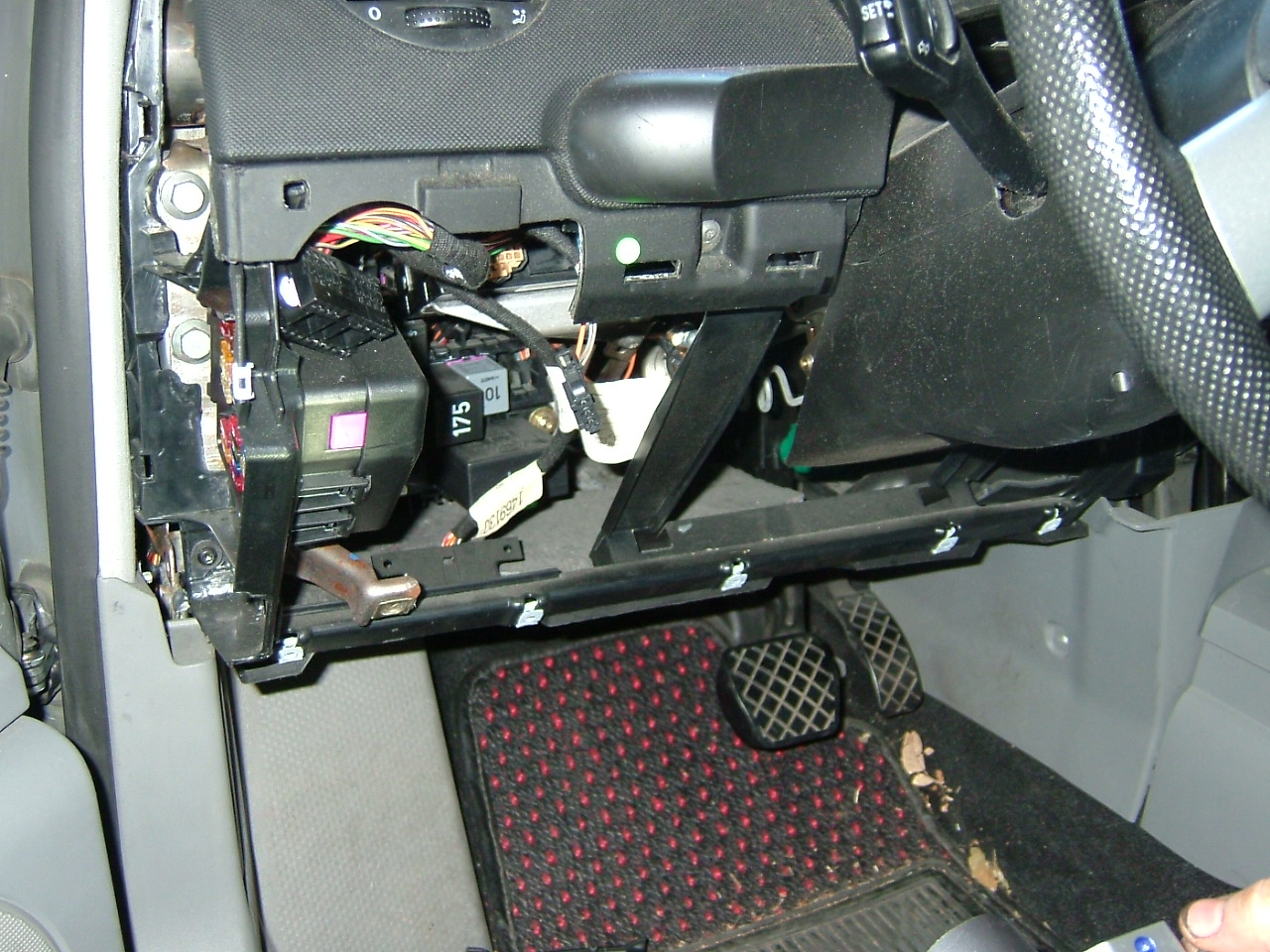 Knee panel removed, exposing the naughty bits of the wiring harness.JPG