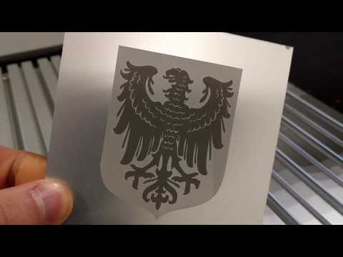 Laser engraving eagle coat of arms on aluminium sheet metal