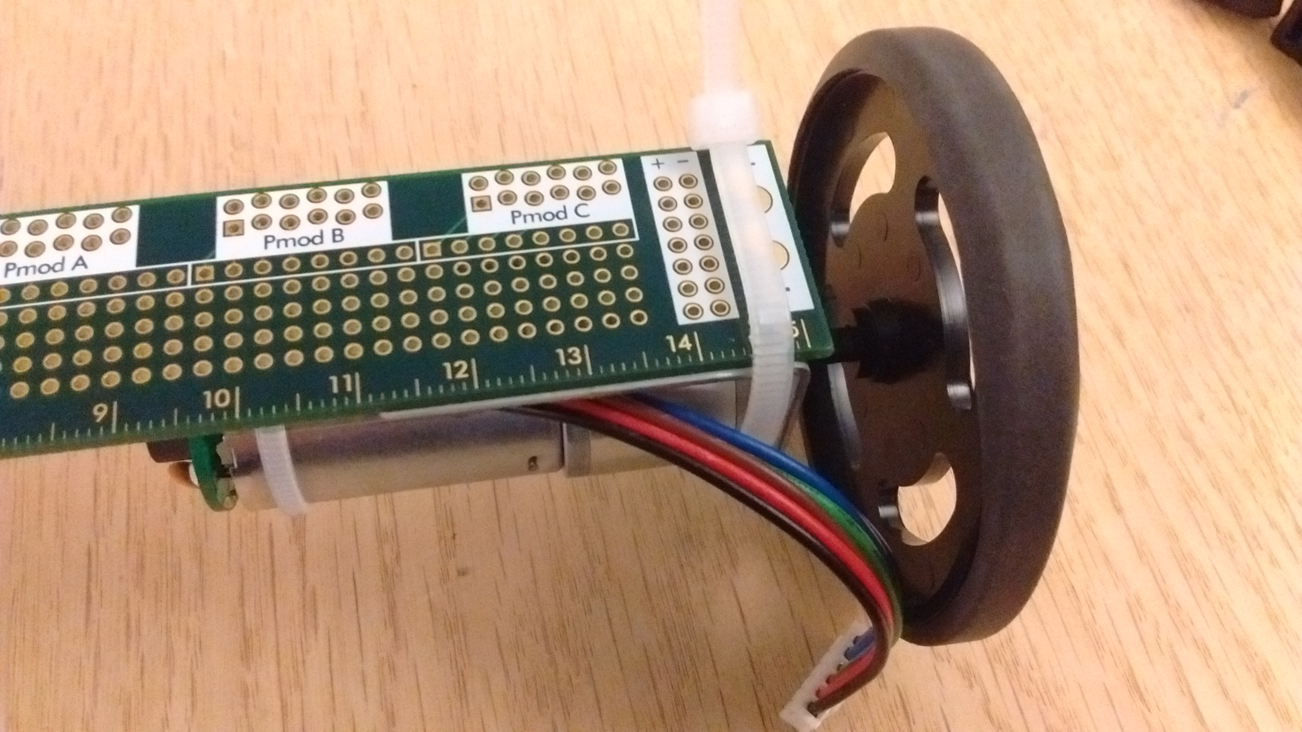 Motor and wheel mounted to the PCB ruler.jpg