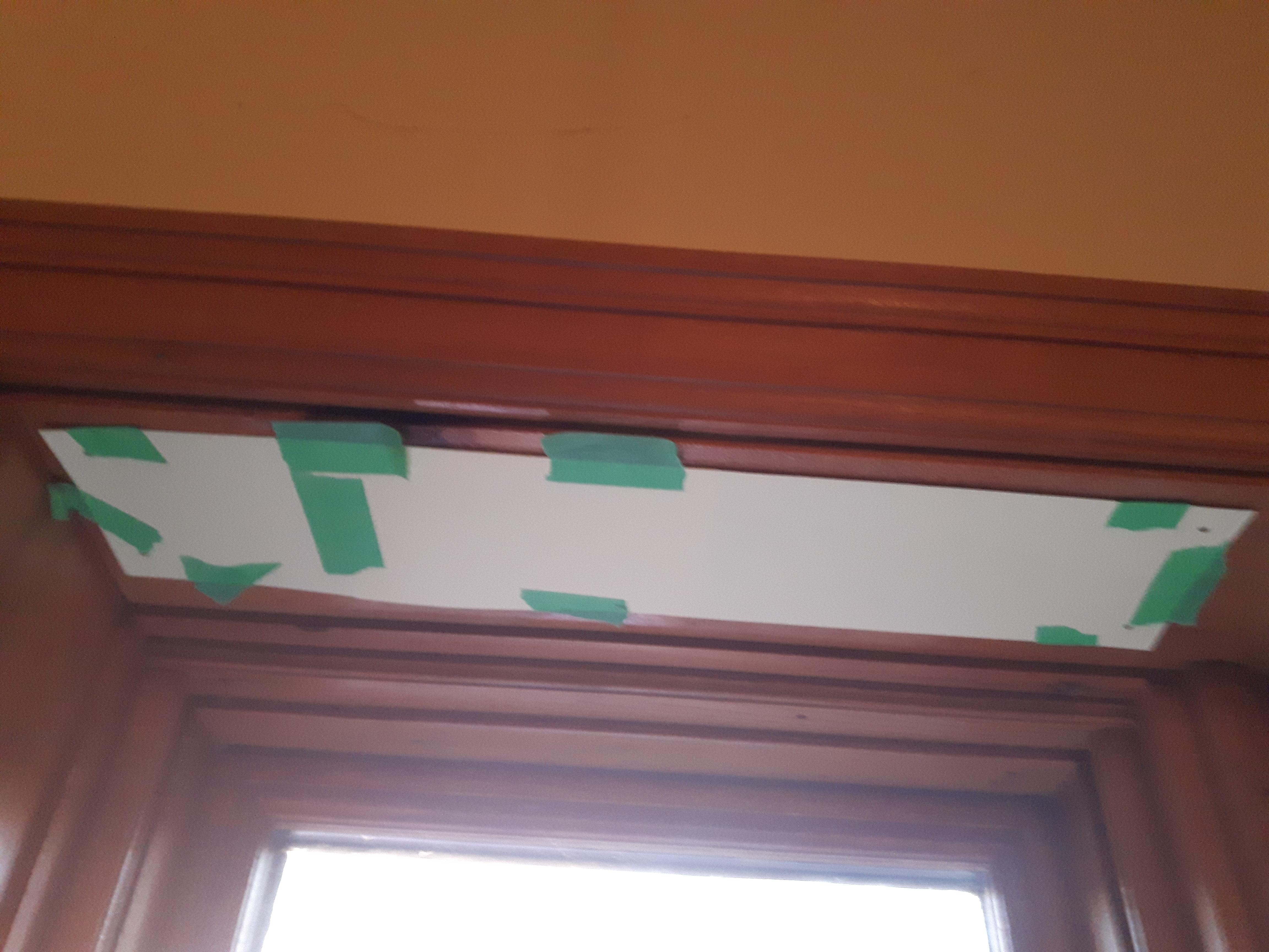 Paper taped to top of window frame.jpg