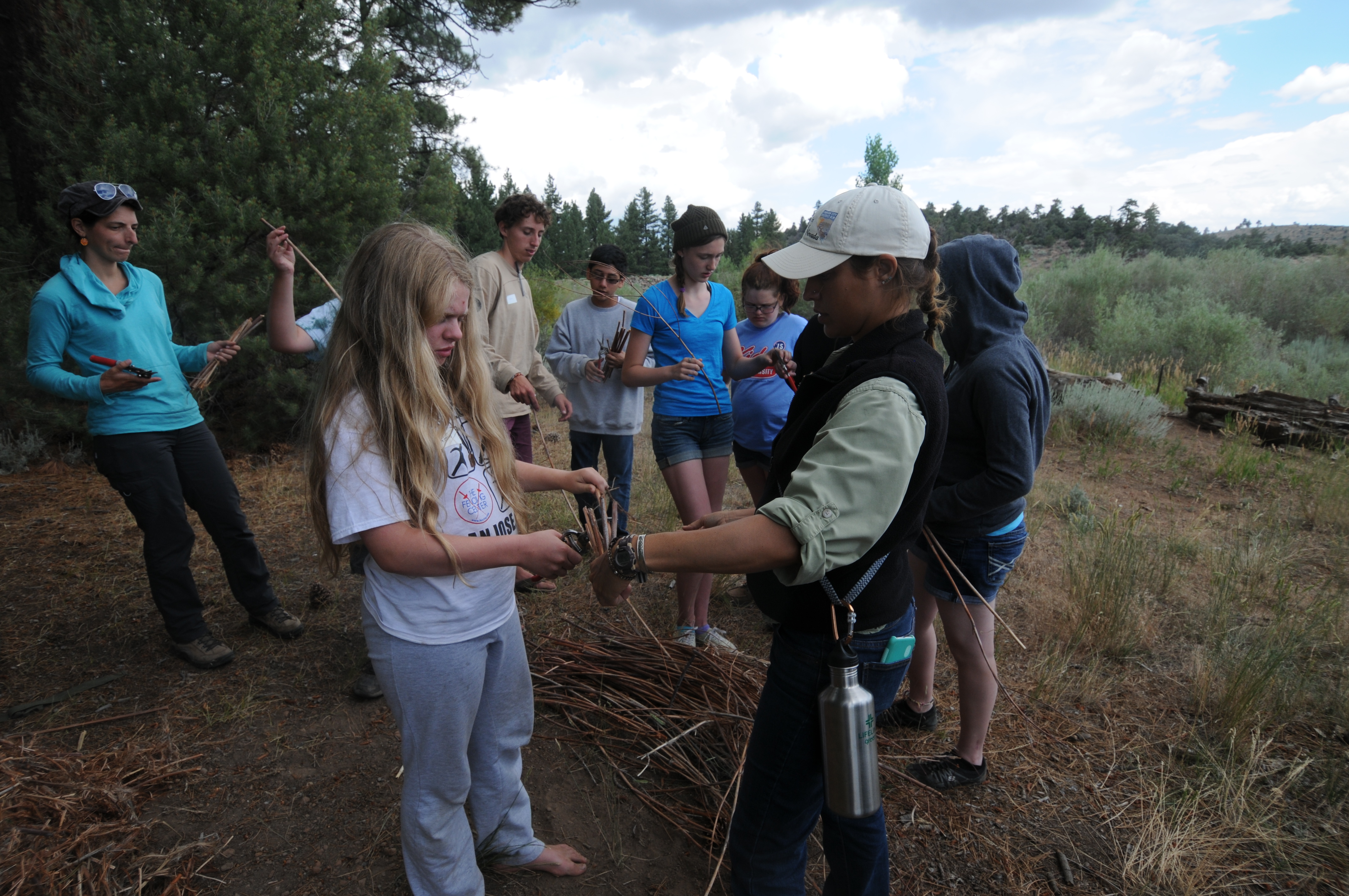 Pilar helping camper with materials.JPG