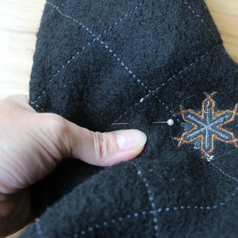 Place a pin on the seam line of the sweater sleeve.jpg