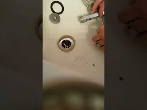 Screwing in the new drain