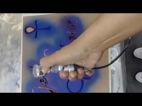 Spray painting a stencil using air brush machine