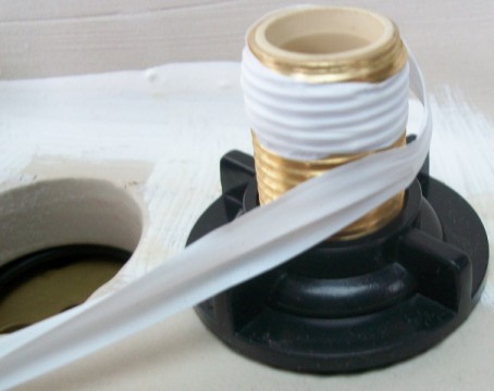 Teflon_tape_wound_around_threaded_pipe.jpg