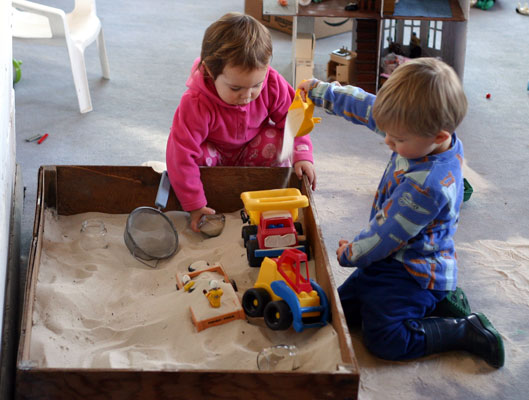 Tots Playing in Sandbox