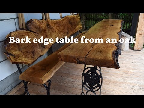 Wooden live edge table from big piece of an oak  - long, natural bark and black metal