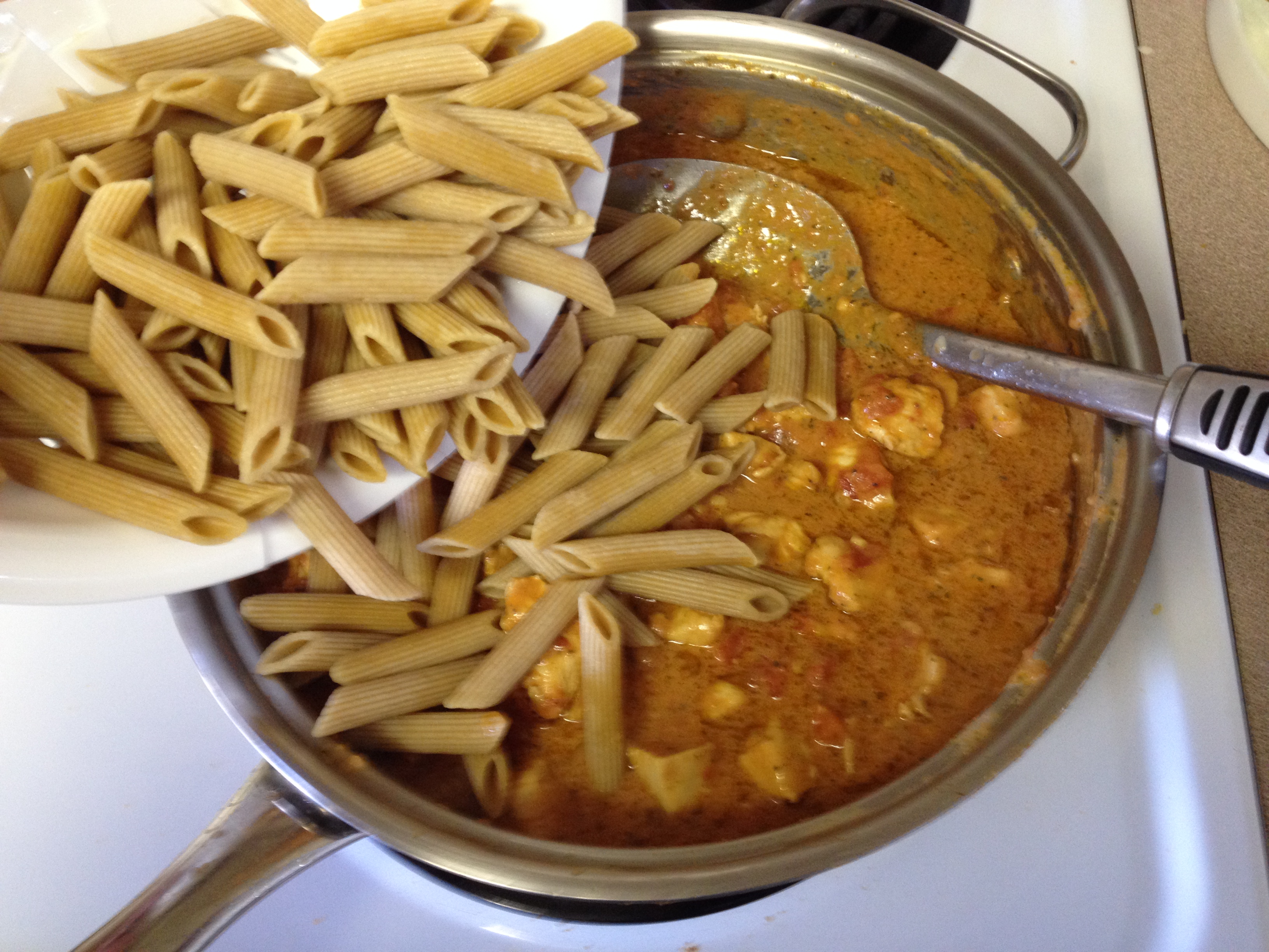 adding whole wheat Penne pasta.JPG