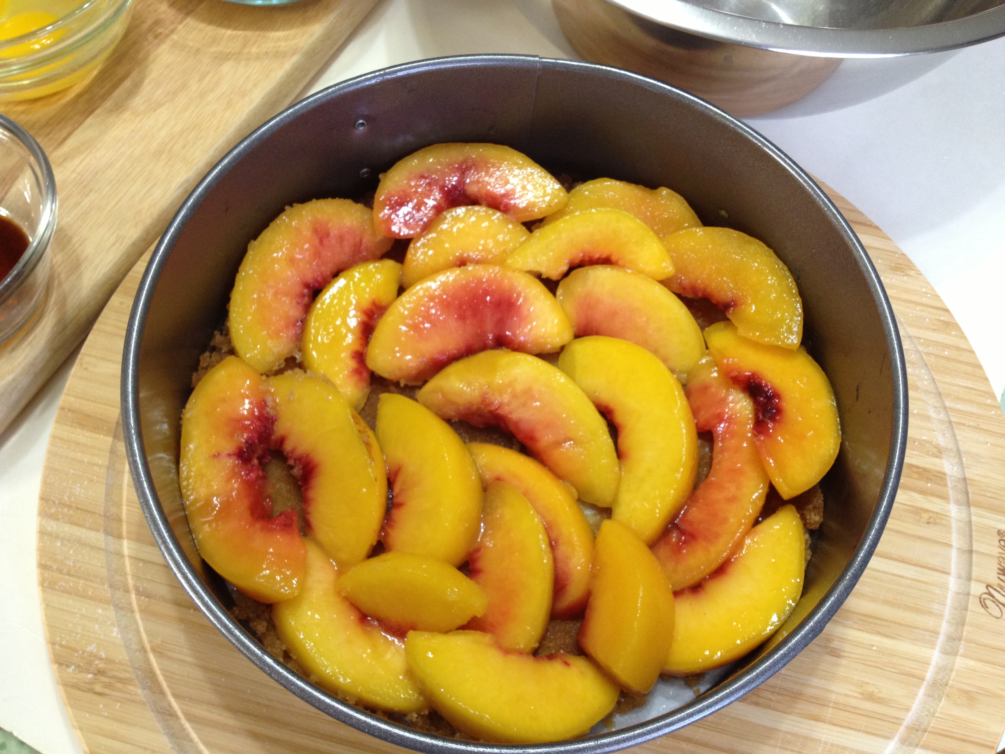 arranging peaches in uniform over brown sugar mixture.jpg