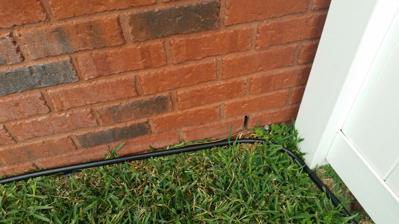 black pipe along brick house.jpg