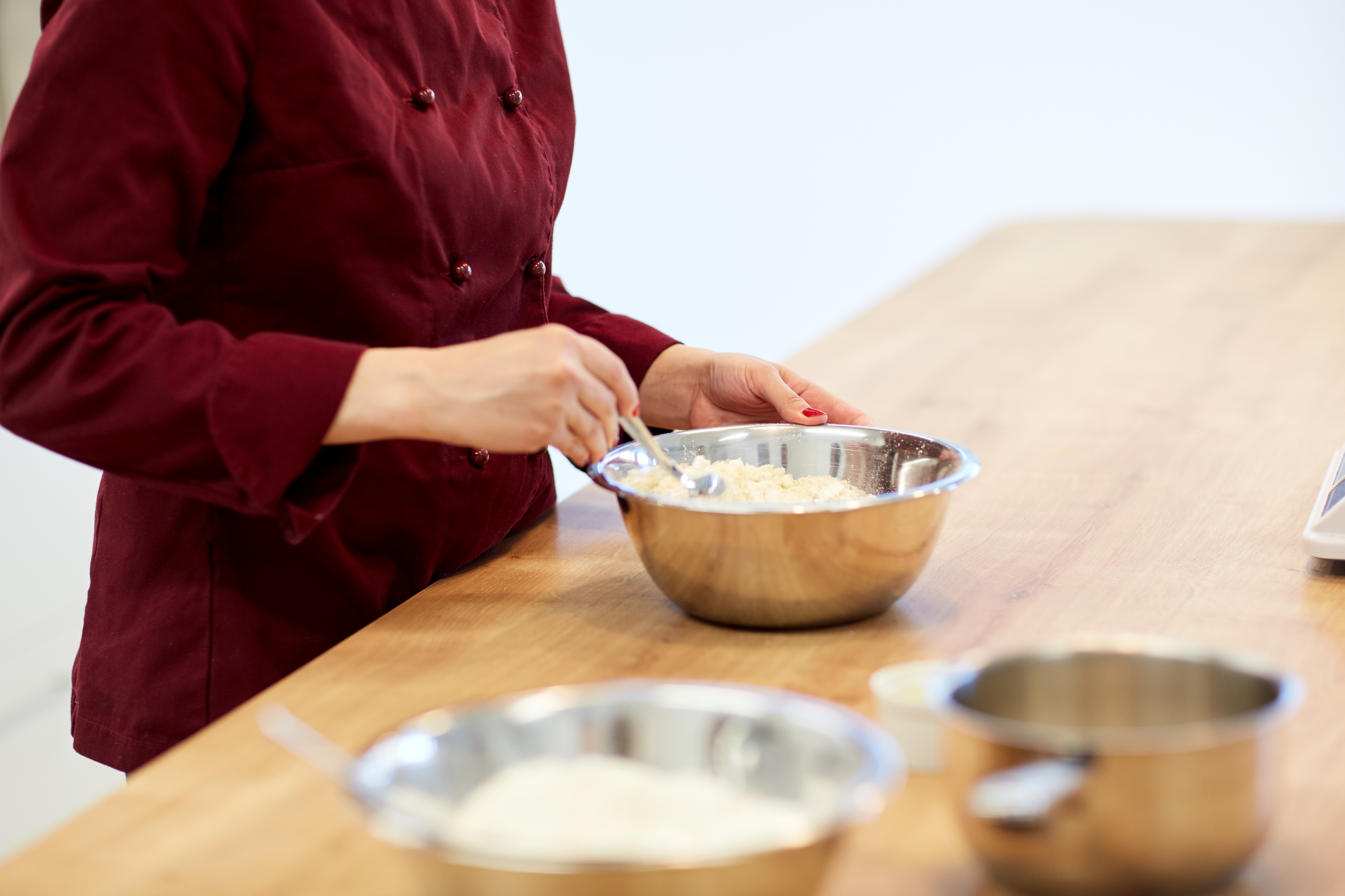 chef-with-flour-in-bowl-making-batter-or-dough-PWUZACK.jpg