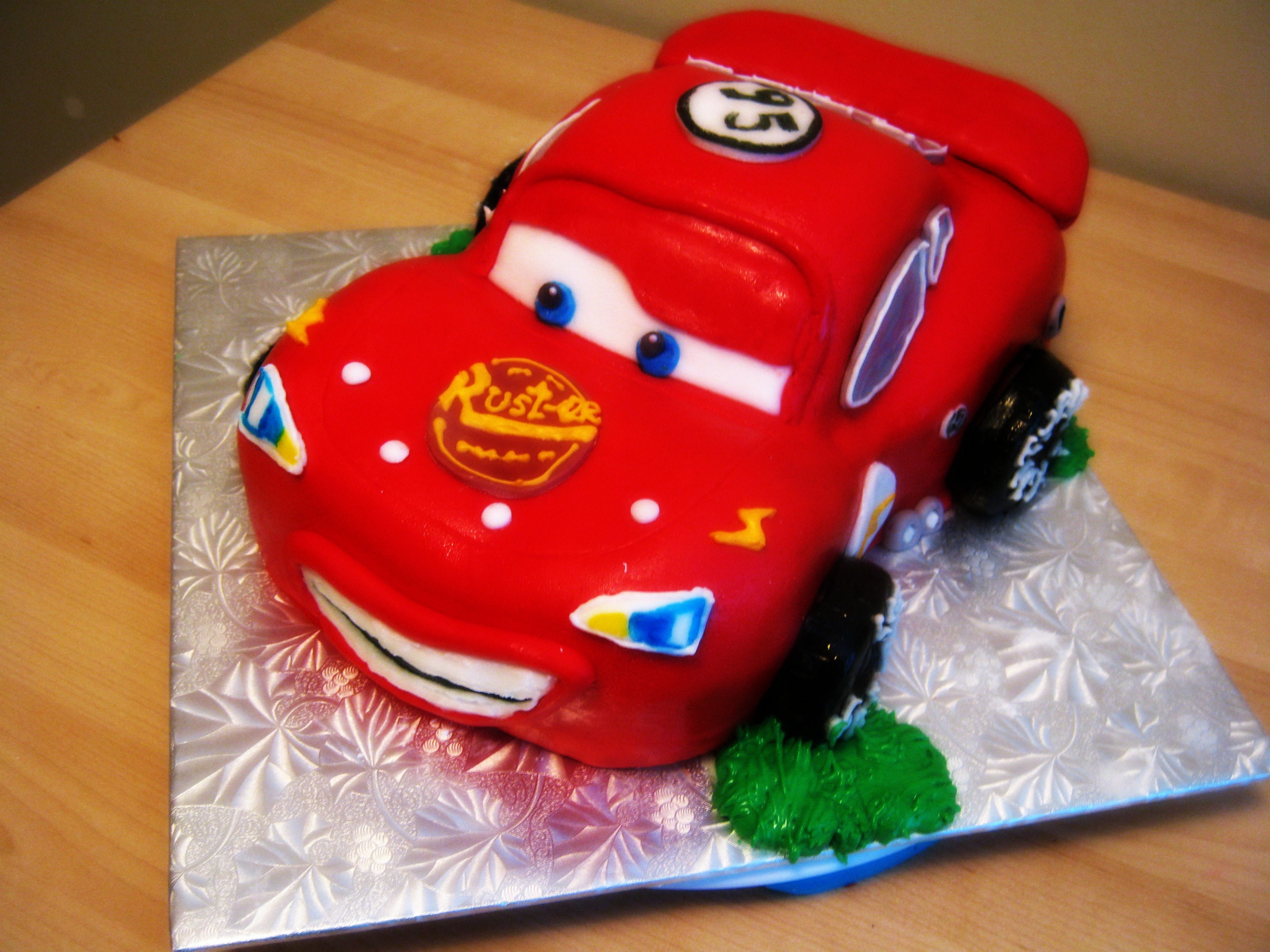 custom sculpted lightening mcqueen cake.jpg