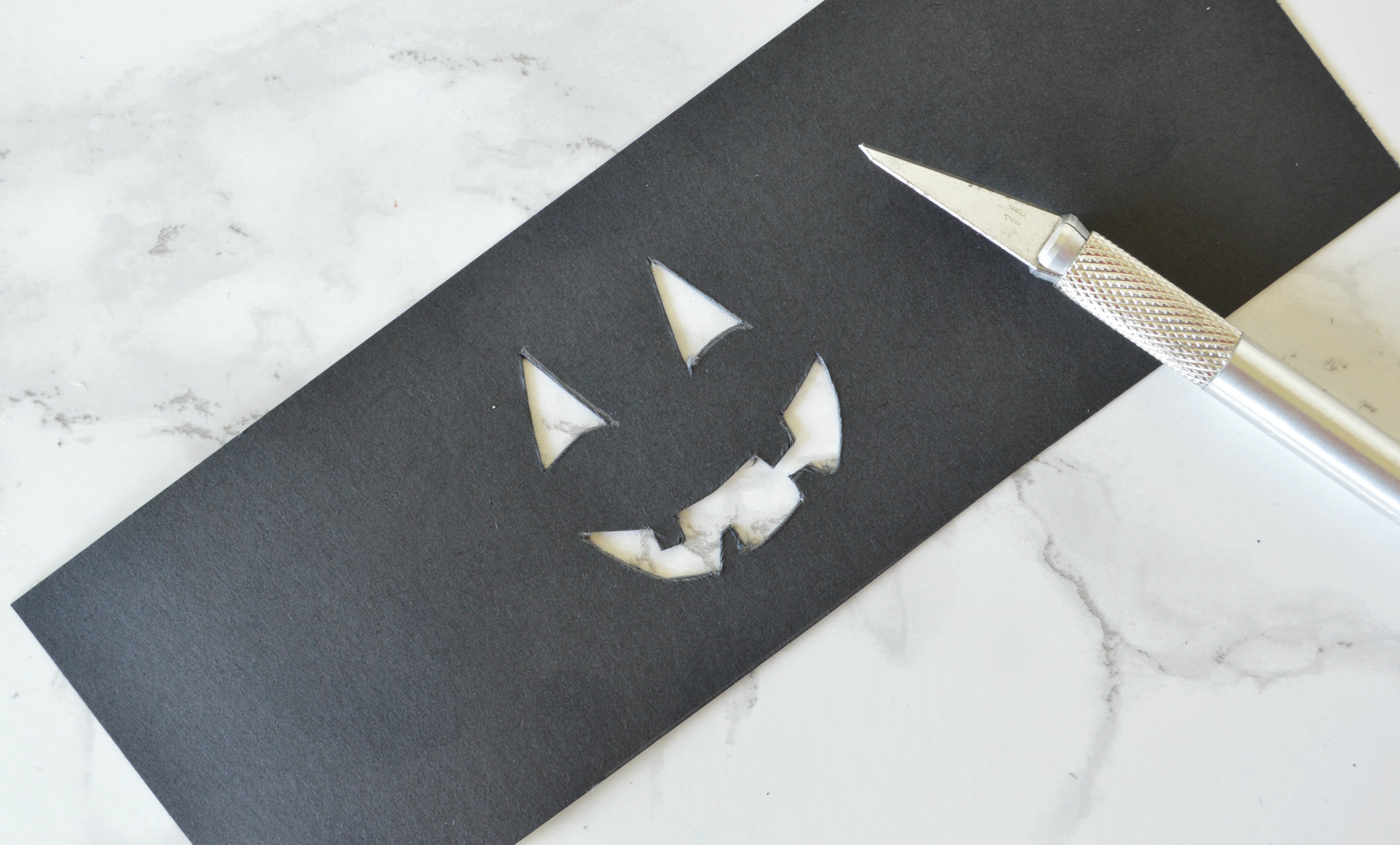 cut the jack o lantern face on cardstock.jpg