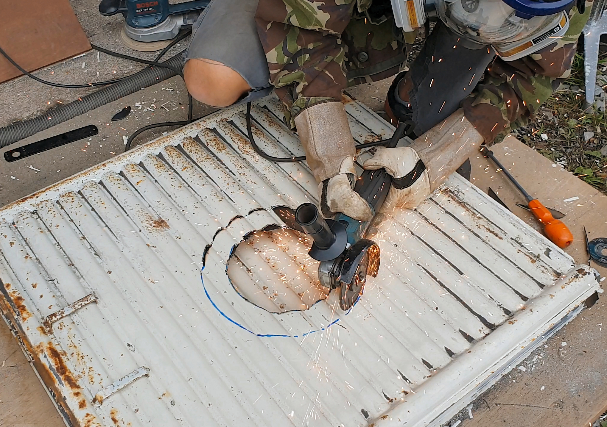 cutting hole for rocket stove griddle.jpg