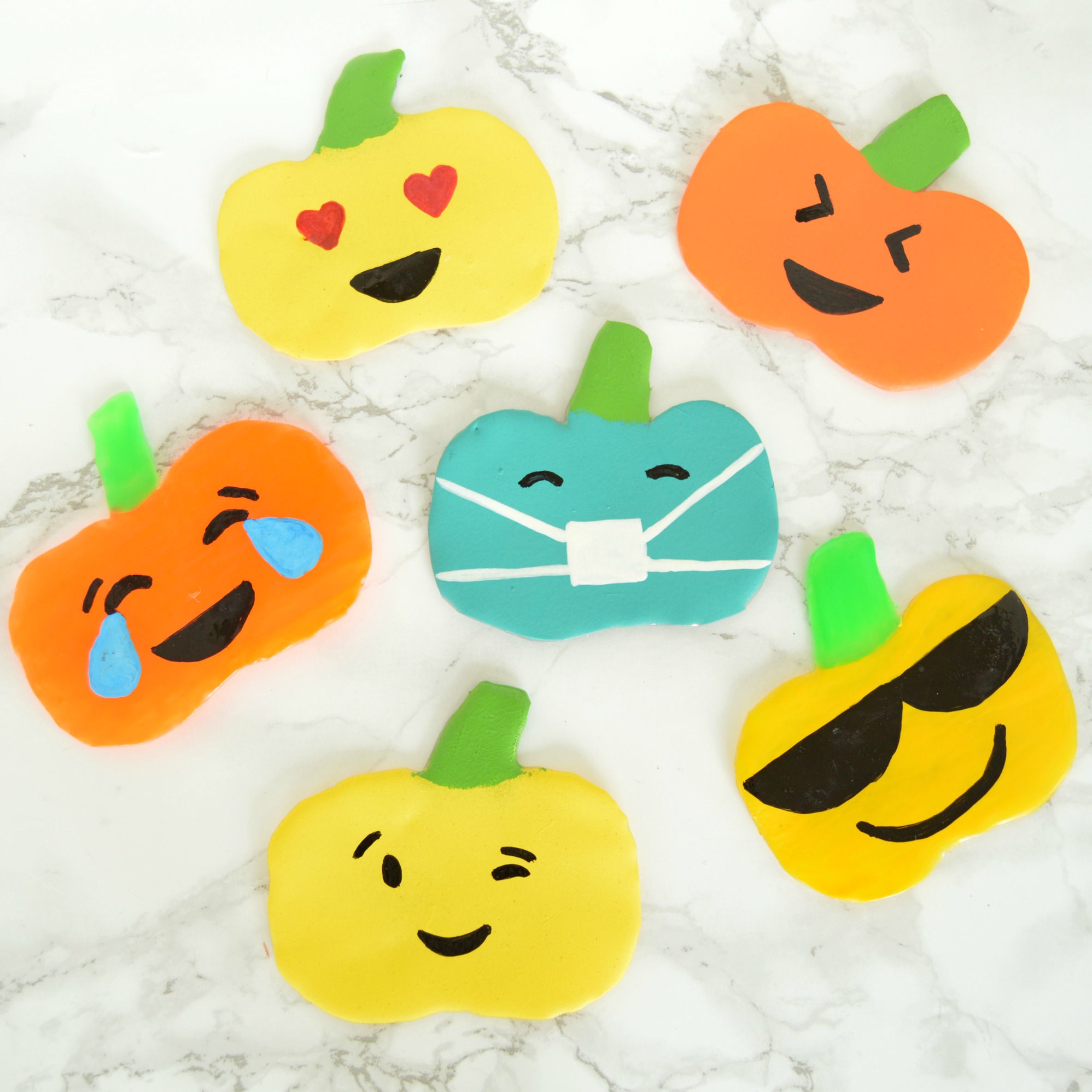 diy emoji pumpkin window clings using hot glue gun.jpg