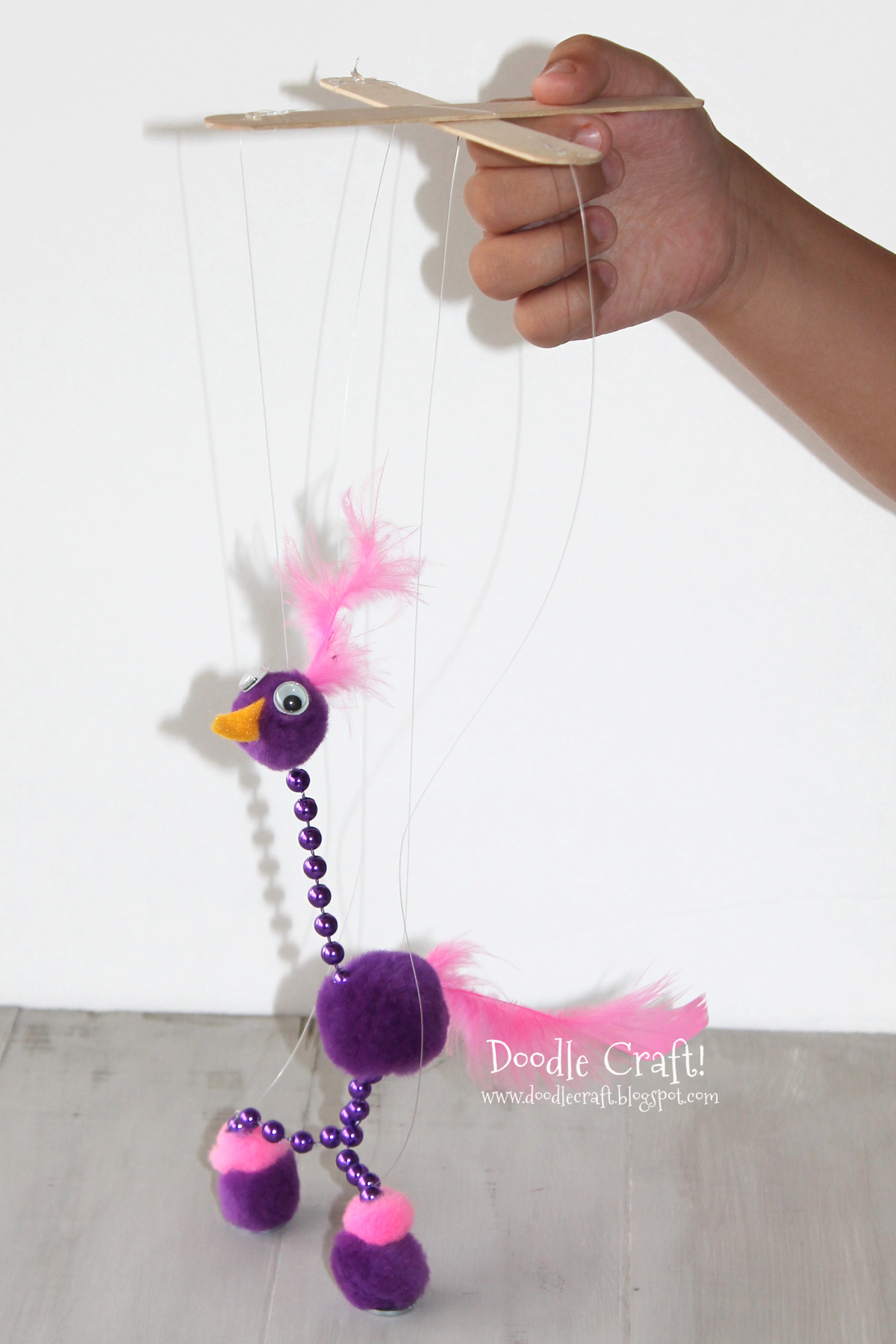 easy diy puppet for kids crafts pom poms feathers felt hot glue beads sticks.jpg