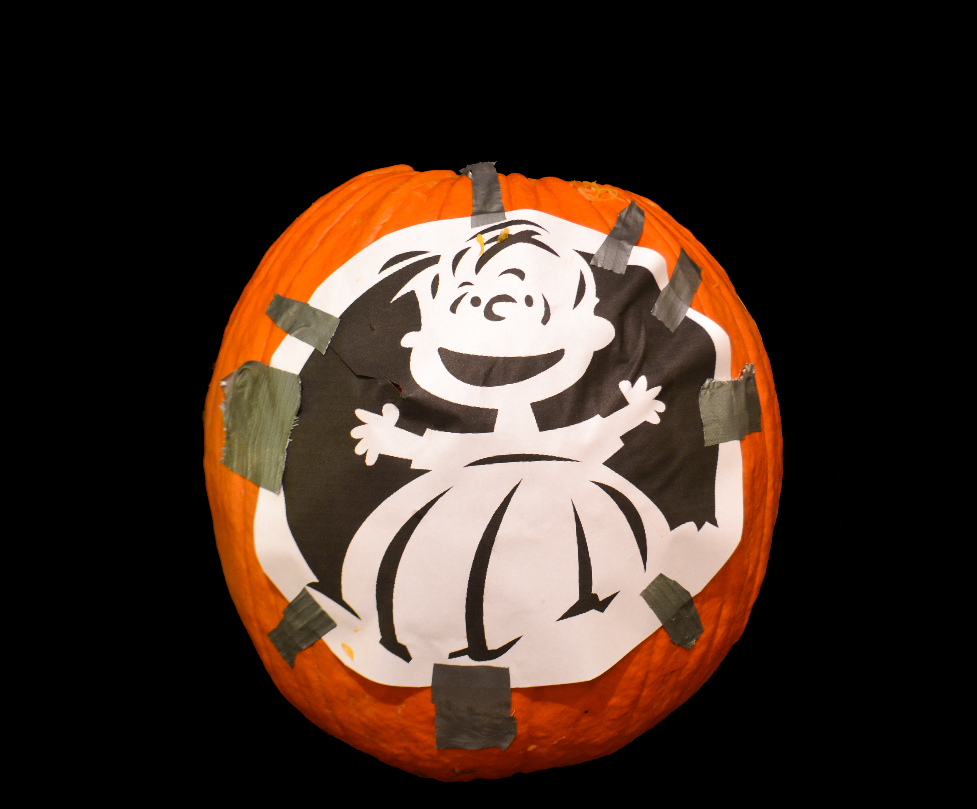 linus stencil taped onto pumpkin.jpg