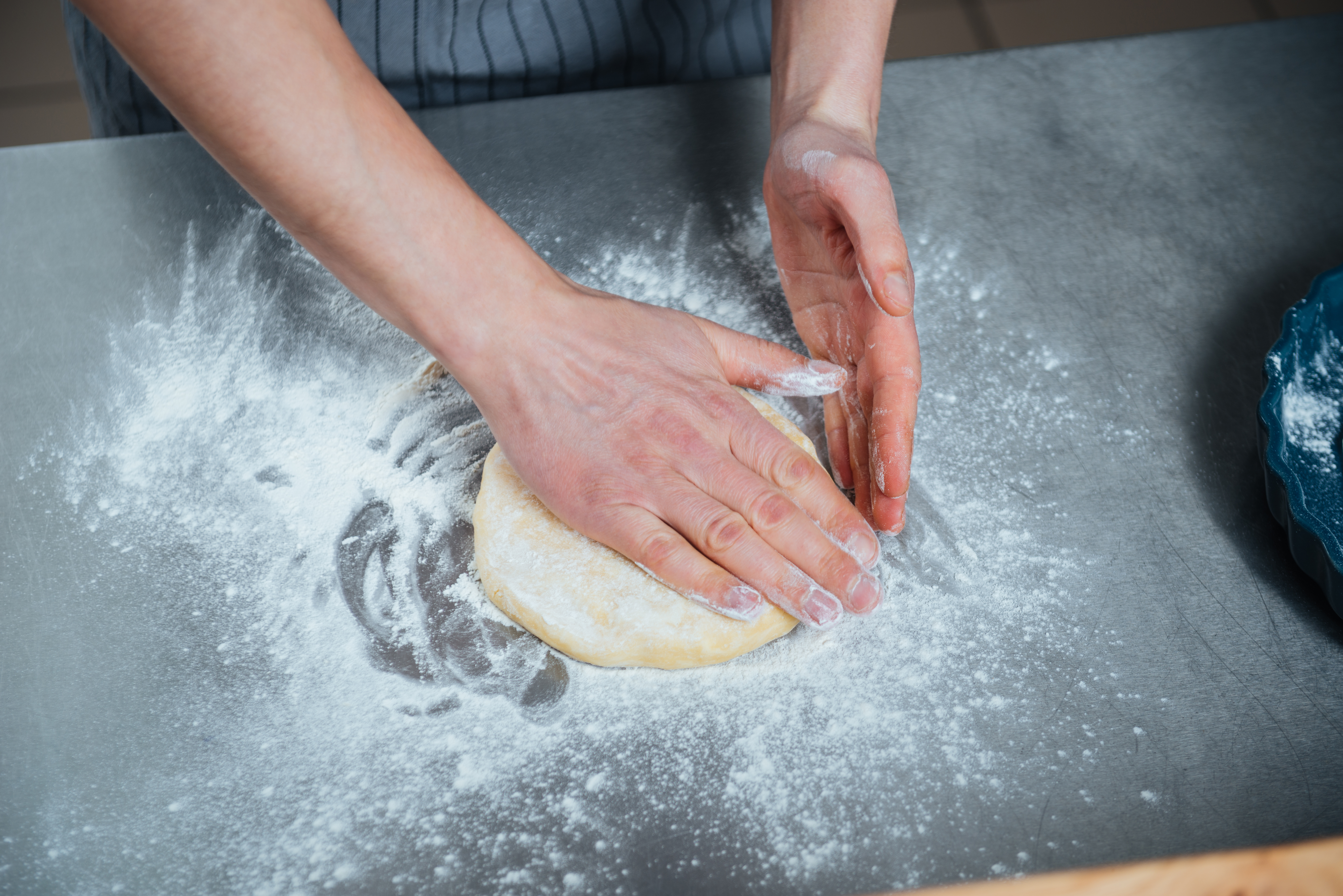 man-hands-making-dough-on-the-table-P5X5VFS.JPG