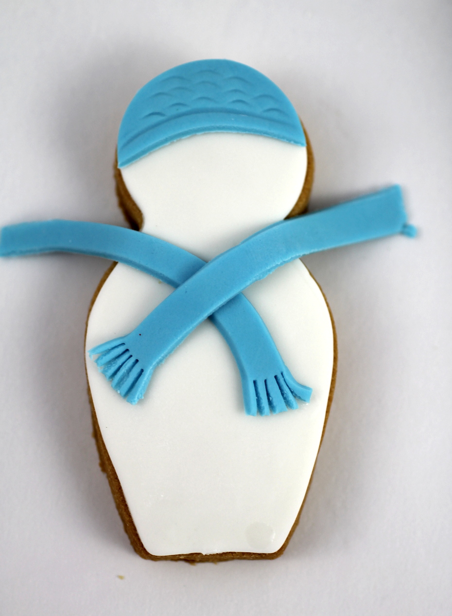 place the scarf on the cookie and then trim the edges snowman cookie.jpg