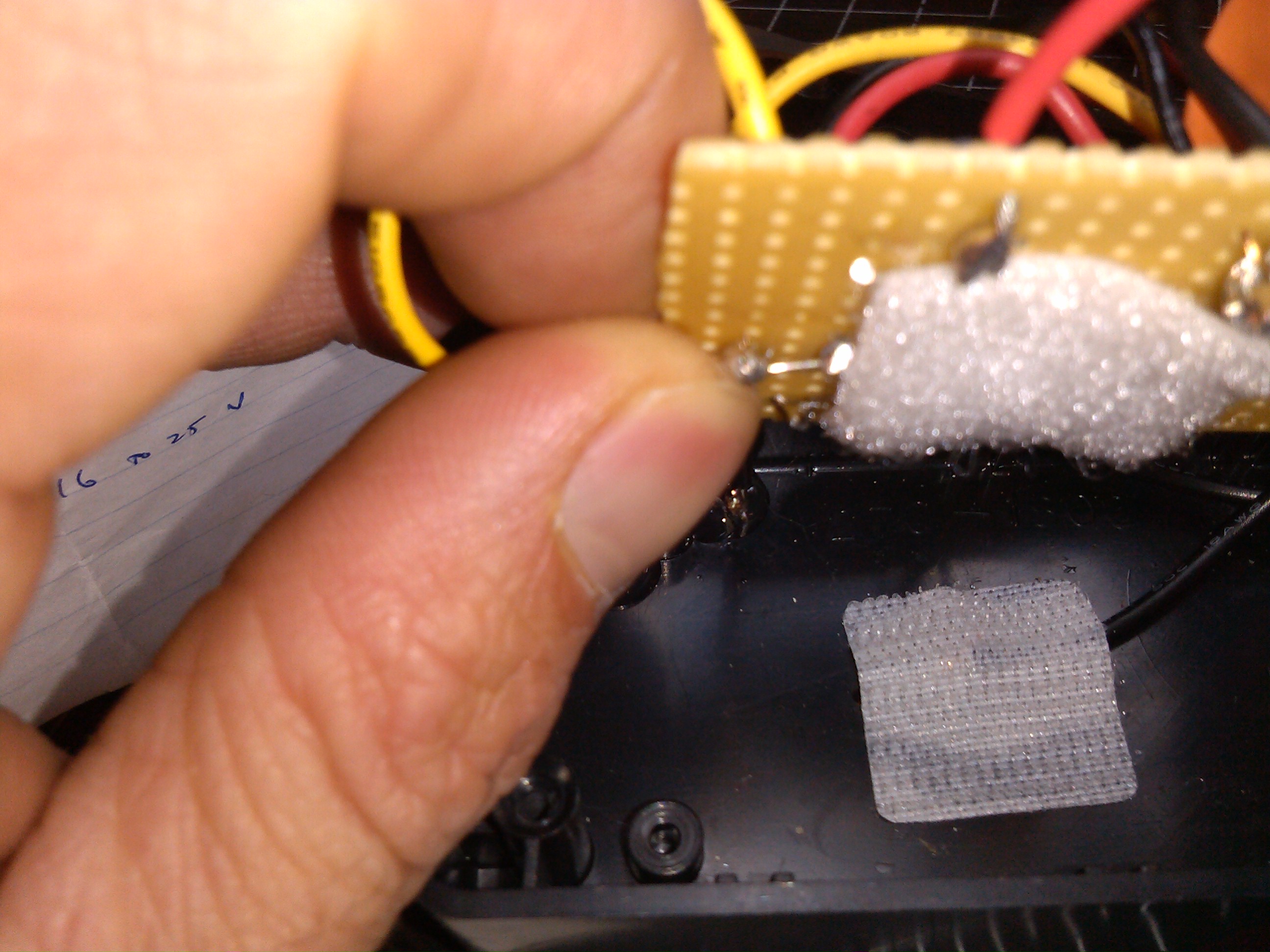 placing velcroed circuit board on to other piece of velcro.jpg