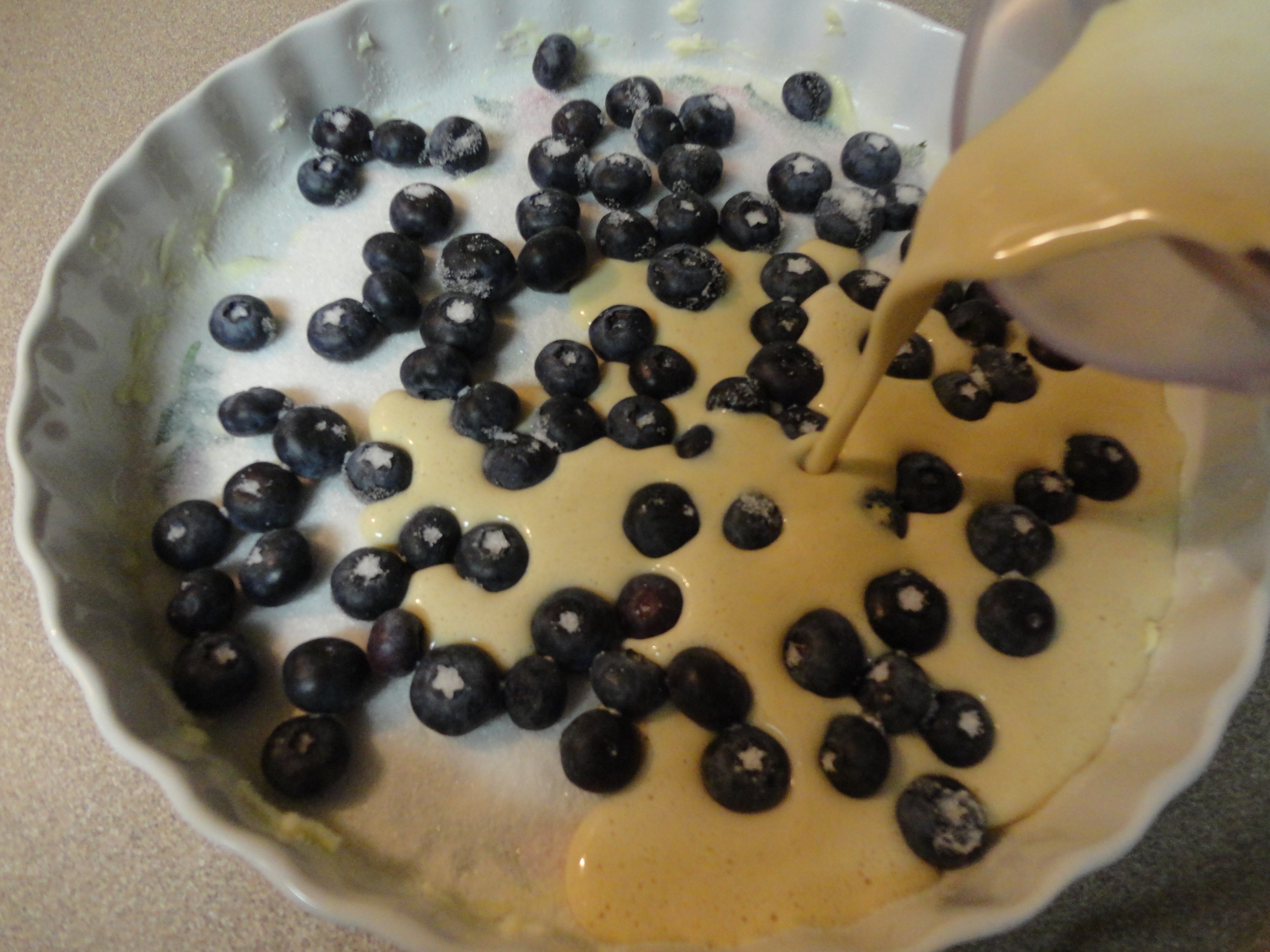 pouring Lemon Blueberry Flognarde over blueberries.JPG