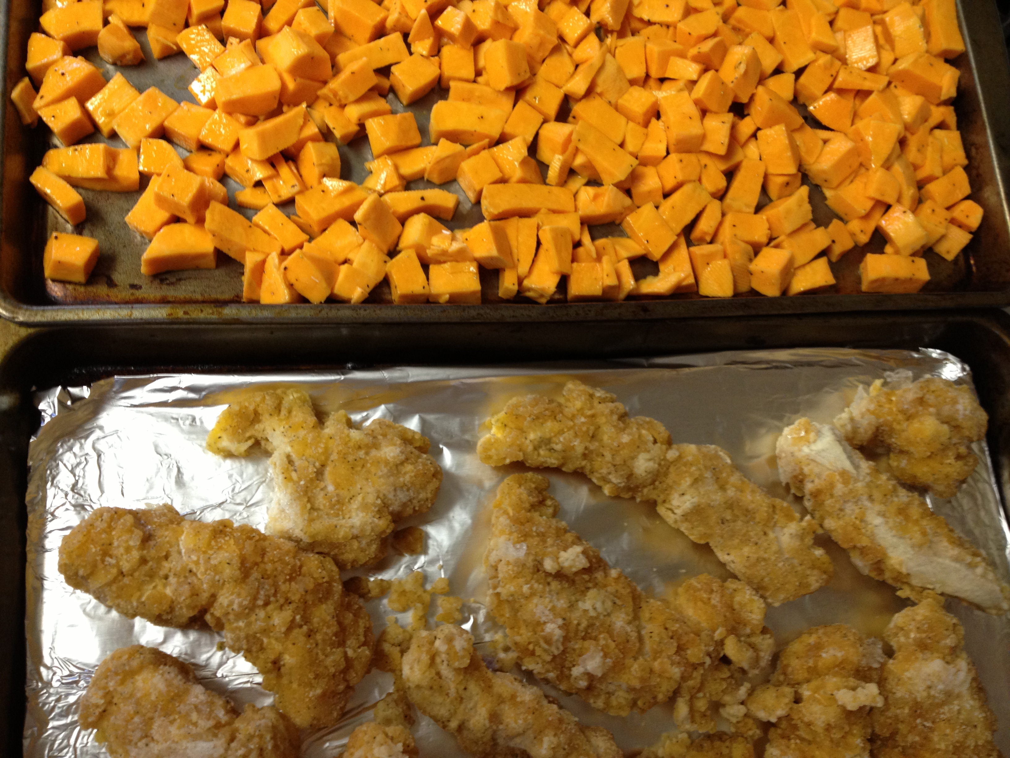 preparing chicken and vegetable on baking sheets.jpg