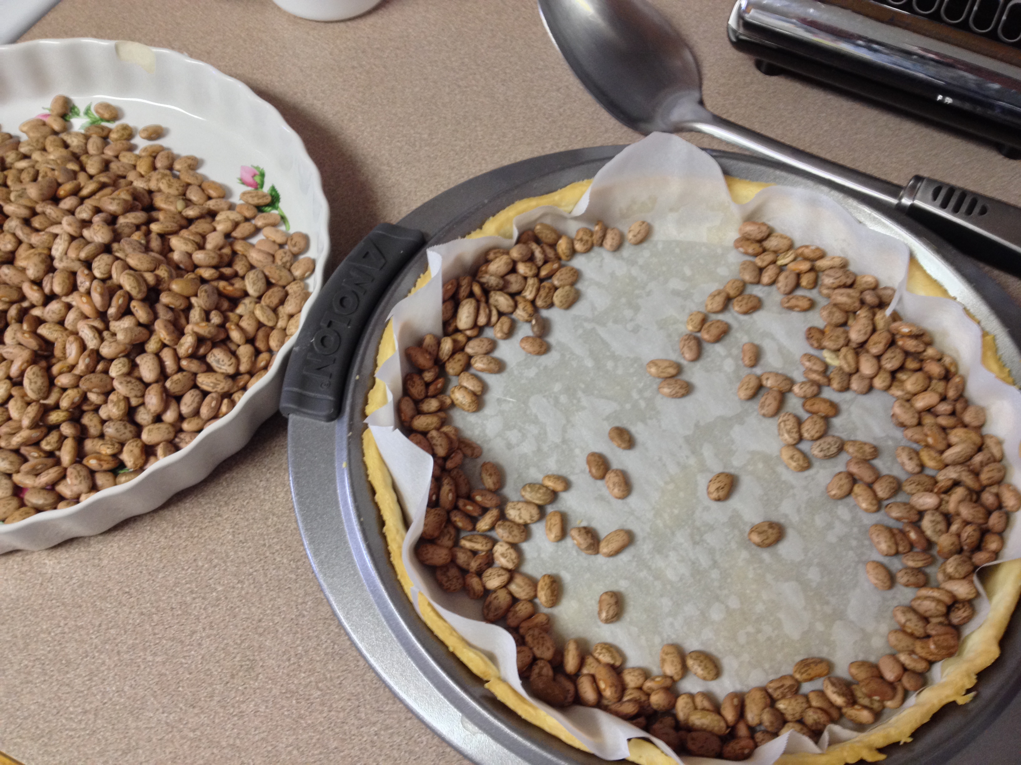 removing dried beans and parchment paper after blind baking.JPG