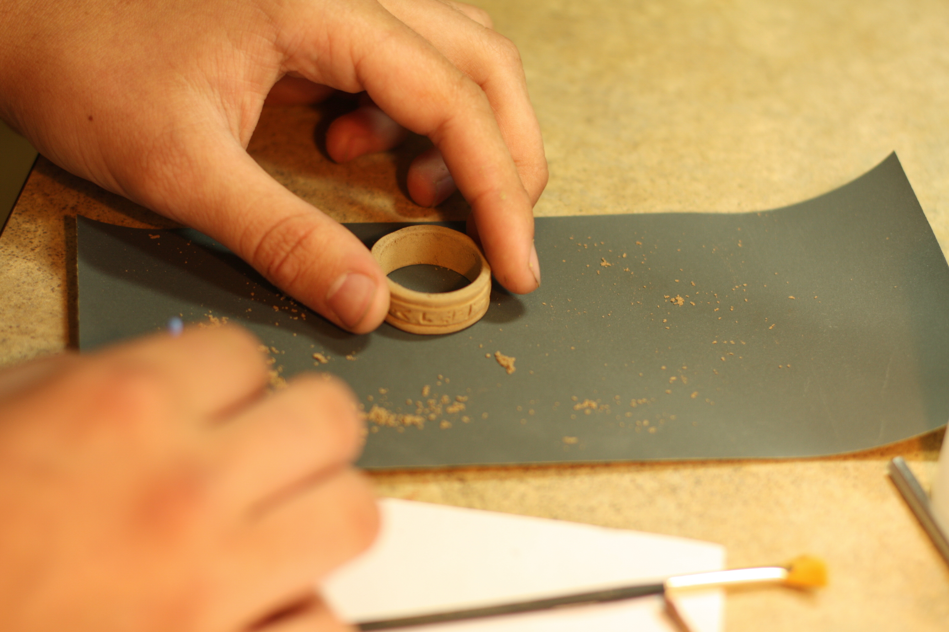 sand ring in figure 8 on fine sandpaper.jpg