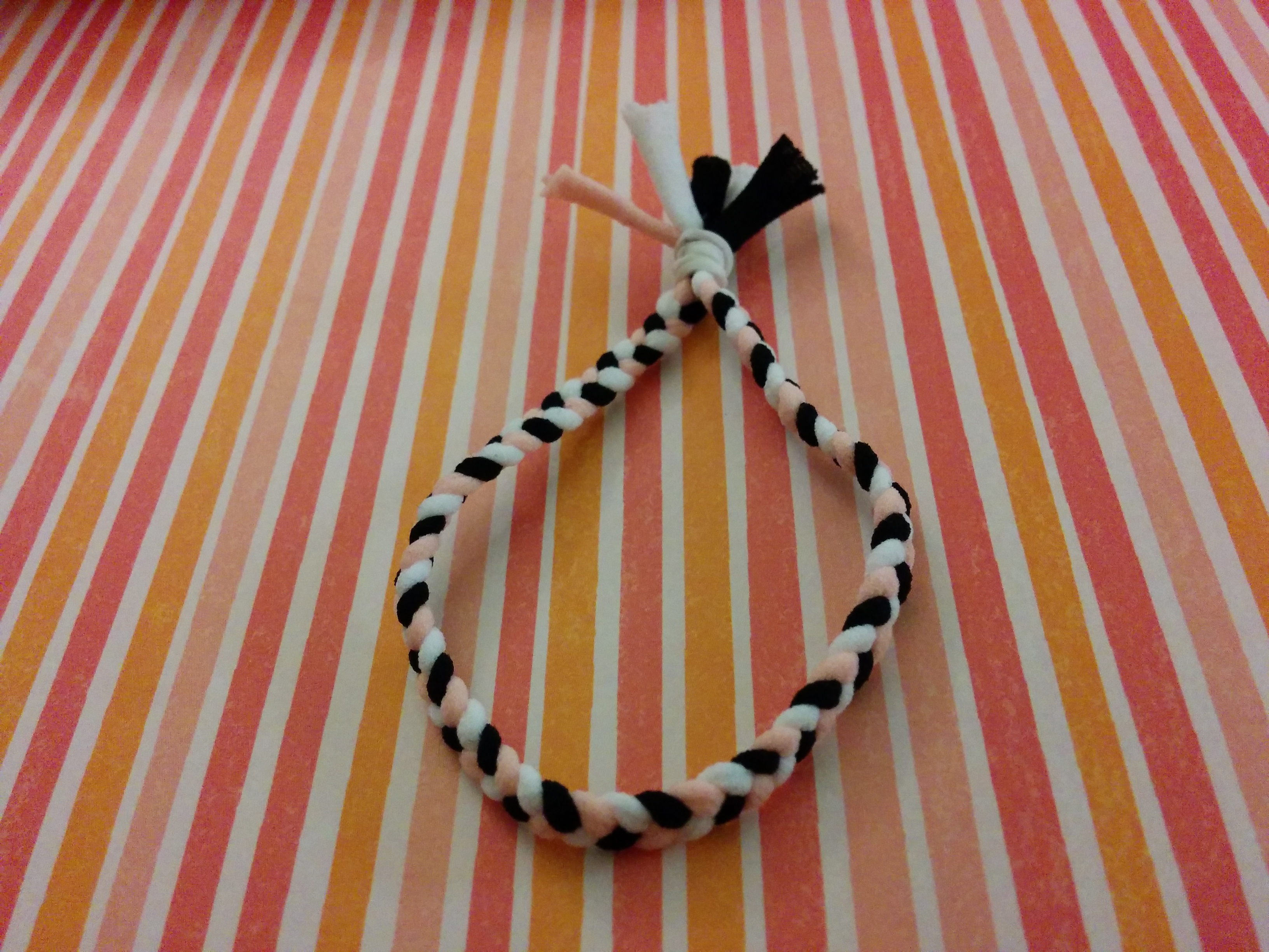 woven hair tie on striped paper.jpg