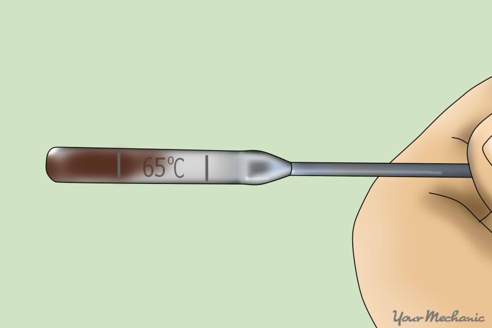 5 - How to Check the Fluids in a Car - hand holding a tramission fluid dipstick showing fluid on it.jpg