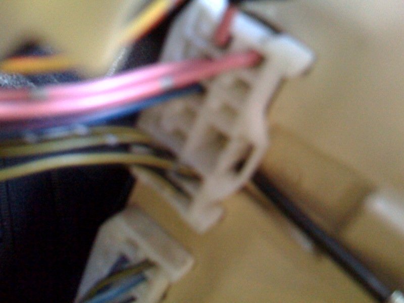 On the back of the fuse box_ we need the top connector_ Pop it out_ then remove the top left pink wire in this picture like we did with the first one_.jpg