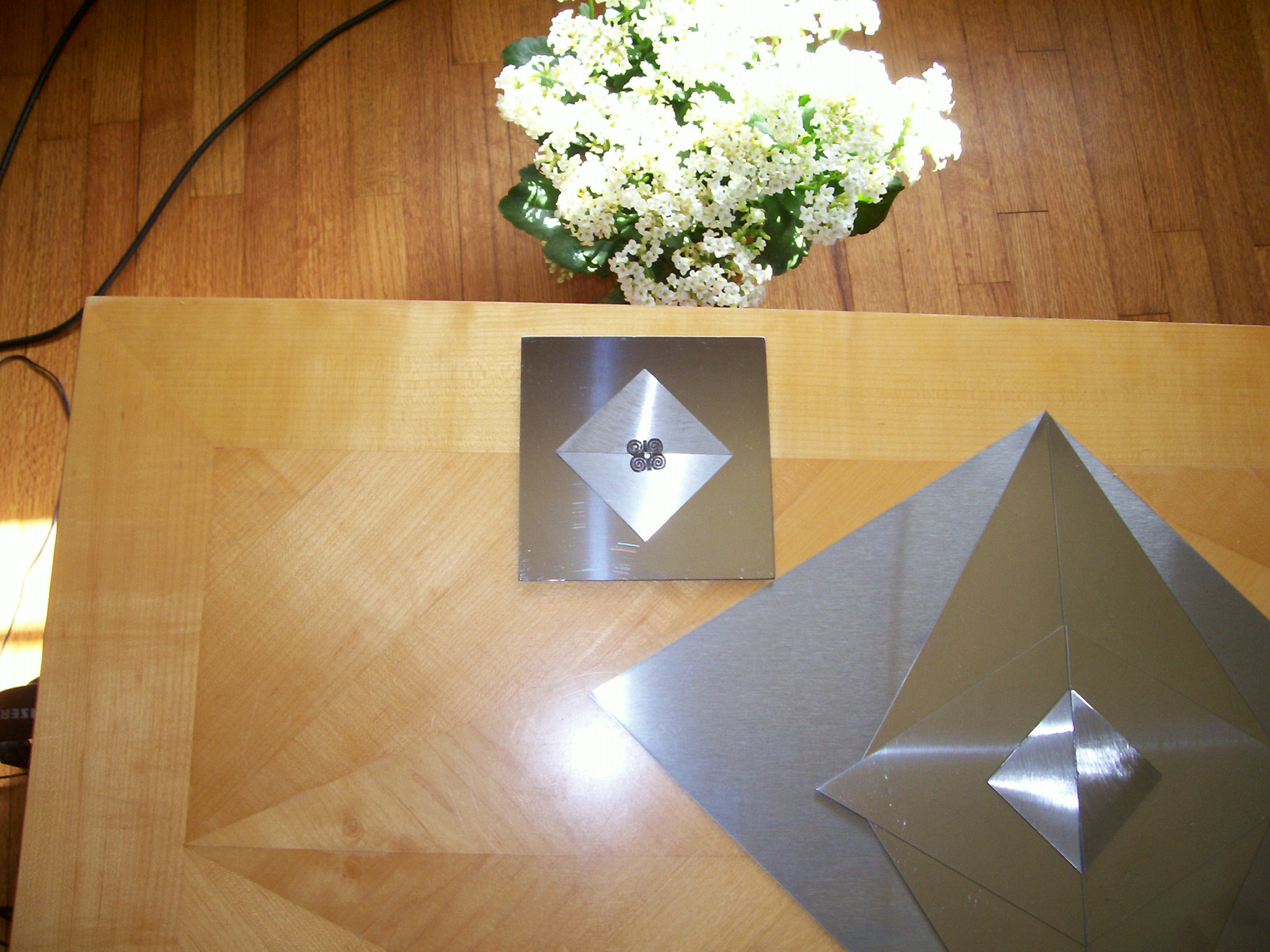 Stainless steel sheet metal designs and electromagnetic-etched tiles.  Polished and brushed finishes.