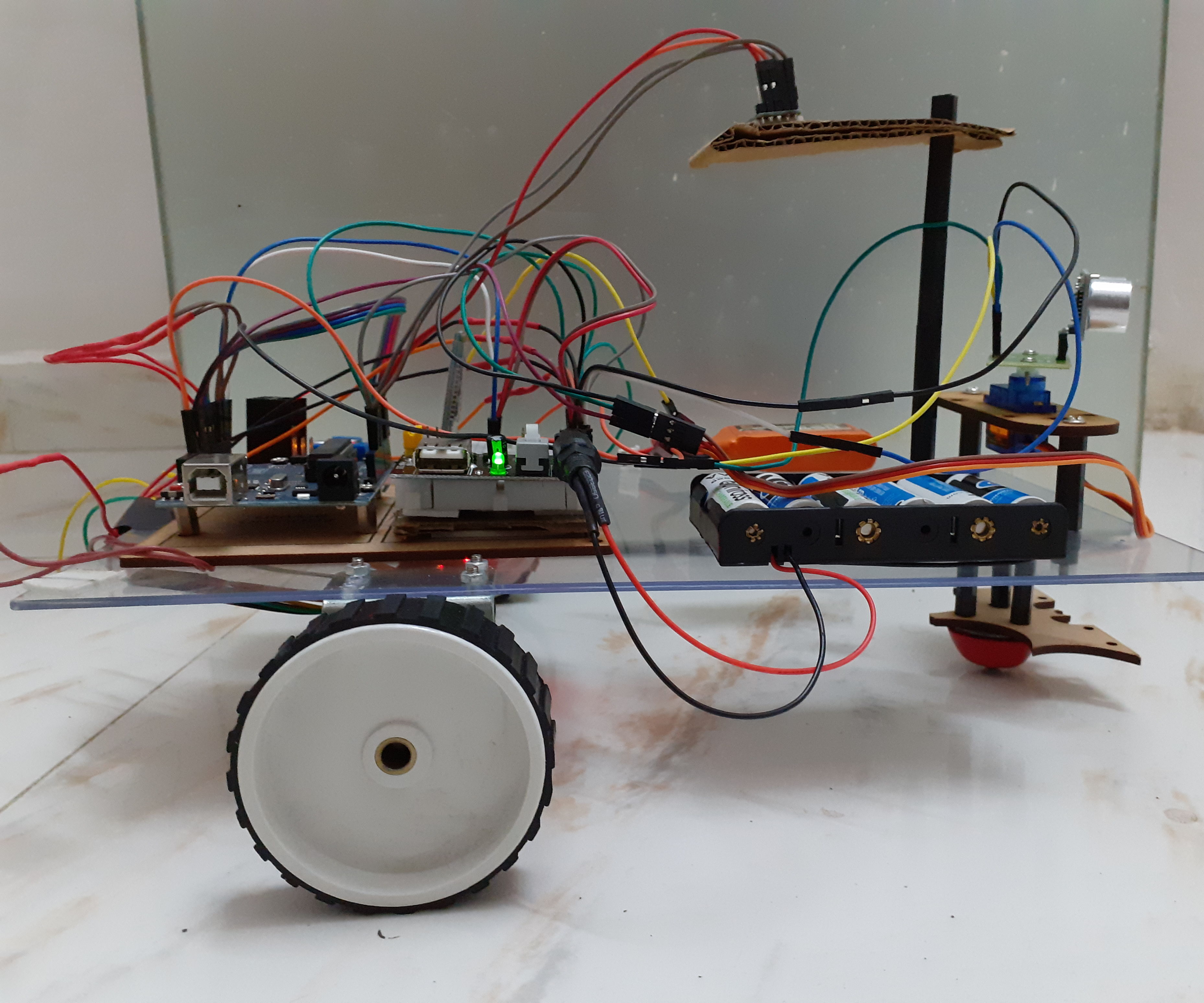 Arduino Robot With Distance , Direction and Degree of Rotation (East, West, North, South) Controlled by Voice Using Bluetooth Module and Autonomous Robot Movement. 