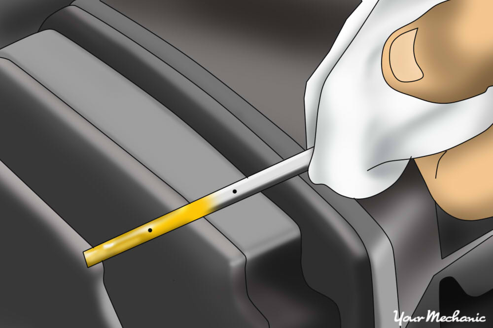 4 - How to Check the Fluids in a Car - a person holding an oil dipstick with oil on the stick itself.jpg