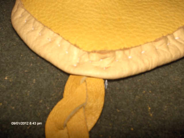 Step 6 Sew the hide braided strips onto the bottom of the curve of the outer exterior on each side.jpg