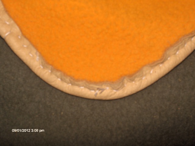 Step 4 a) image of hand stitching on the inside which catches the lining- the edge of the hide and lining are equal when the hide strip is sewn over.jpg